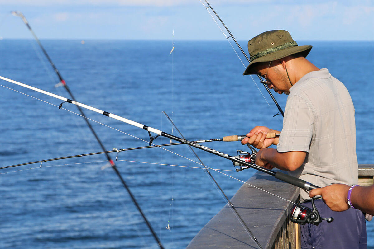 Person fishing on open coastal water